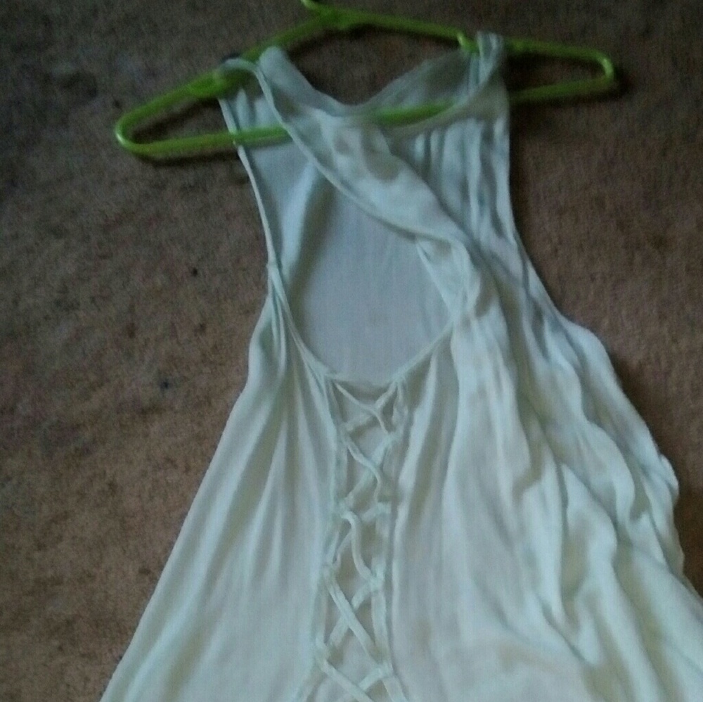 Tank top with criss cross cutout sides. M